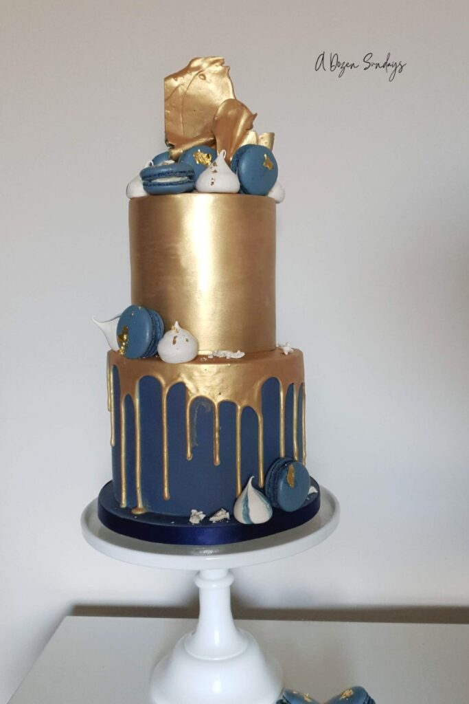 A two tier chocolate drop birthday cake in gold and navy