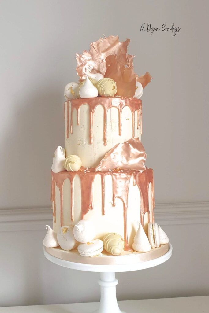 A two tier rose gold chocolate drip birthday cake