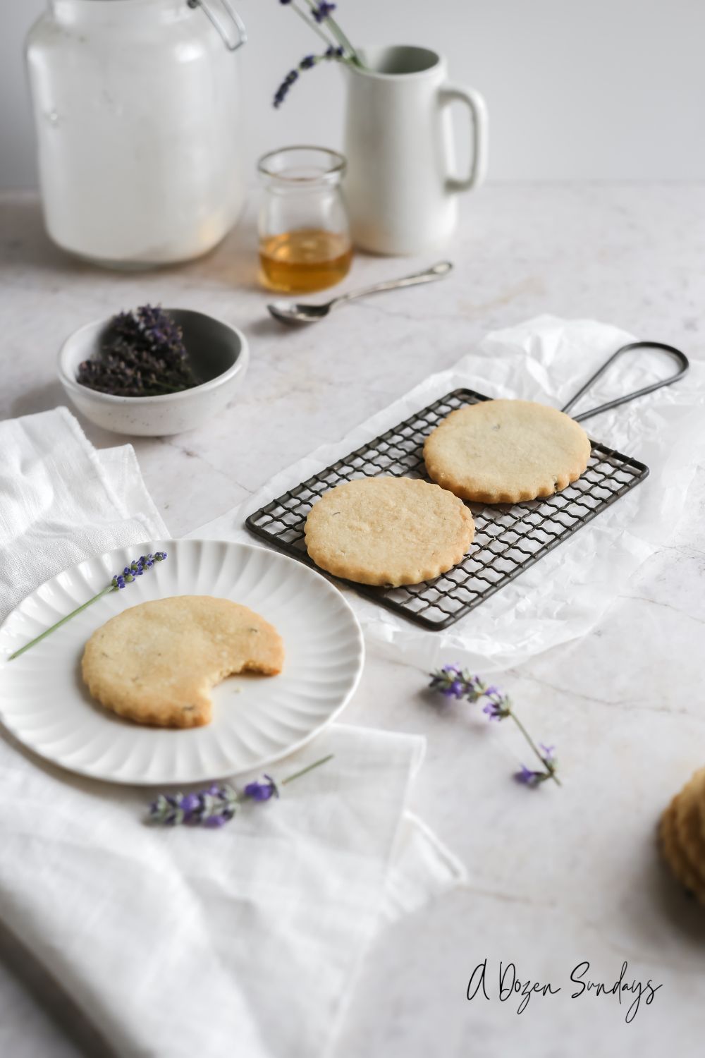 Lavender honey shortbread cookies on a plate - A Dozen Sundays
