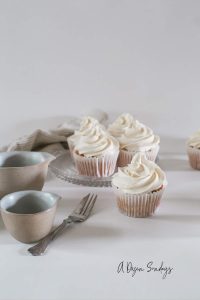 Easy Vanilla Cupcake Recipe - Vanilla Cupcake in White Wrapper with White Buttercream - A Dozen Sundays
