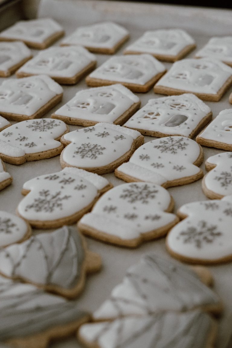 Cookies shaped like mittens decorated with royal icing