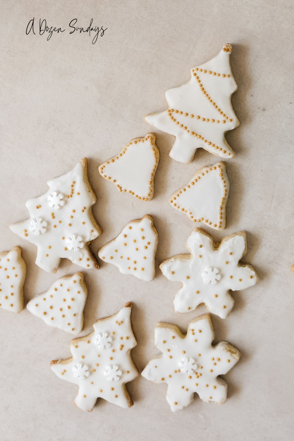 White and gold iced Christmas cookies laid out in the shape of a Christmas tree - A Dozen Sundays