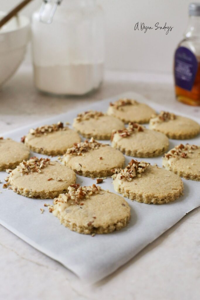 Pumpkin Spice Pecan Shortbread Cookies With Maple Glaze on a baking sheet