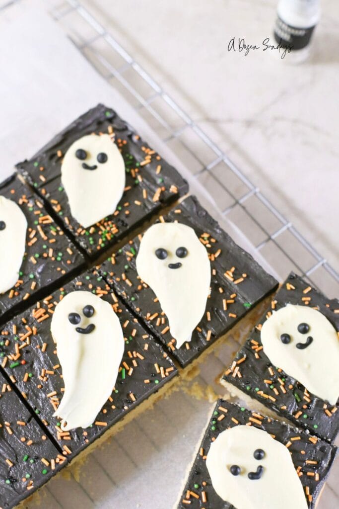 Halloween cookie bar, a shortbread cookie bar with black buttercream and a white chocolate ghost topper