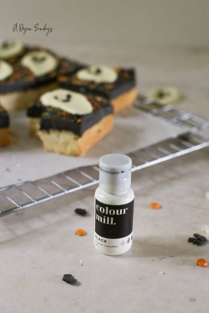 Halloween cookie bar, a shortbread cookie bar with black buttercream and a white chocolate ghost topper
