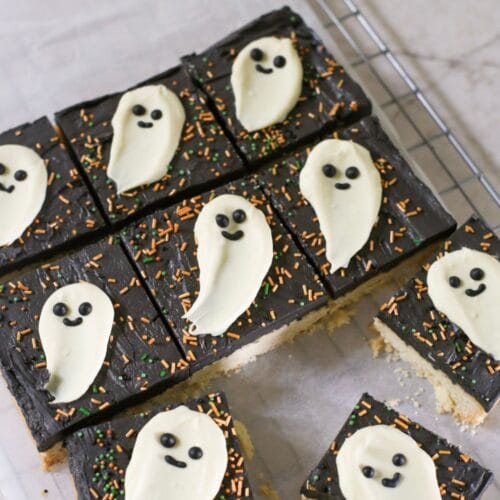 Halloween cookie bar, a shortbread cookie bar with black buttercream and a white chocolate ghost topper