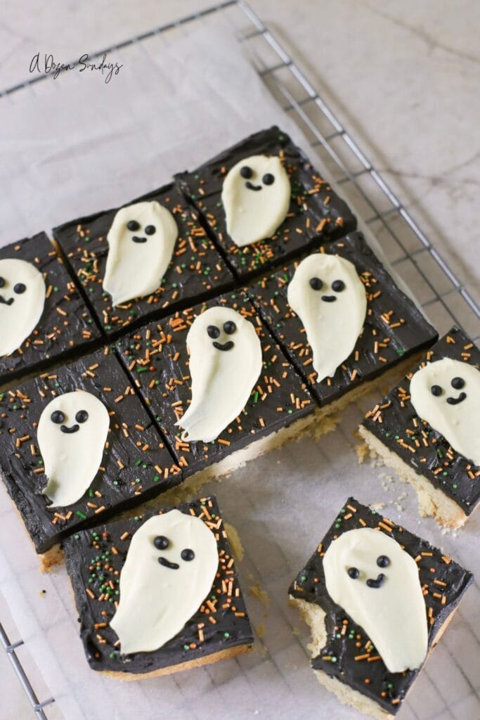 Halloween cookie bar, a shortbread cookie bar with black buttercream and a white chocolate ghost topper
